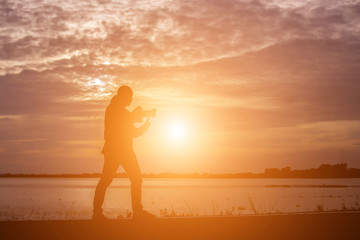 Fototapeta na wymiar Man show hands silhouette sunset background