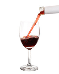 Pouring red wine into glass with splashing., Isolated white background.