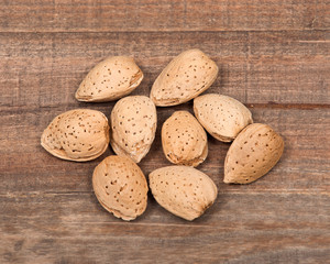 Raw organic almonds in shell on wooden vintage tray