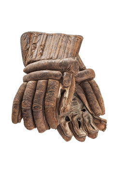 A pair of worn leather hockey gloves isolated on a white background.