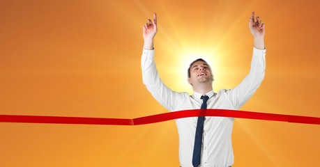 Excited businessman crossing the finish line
