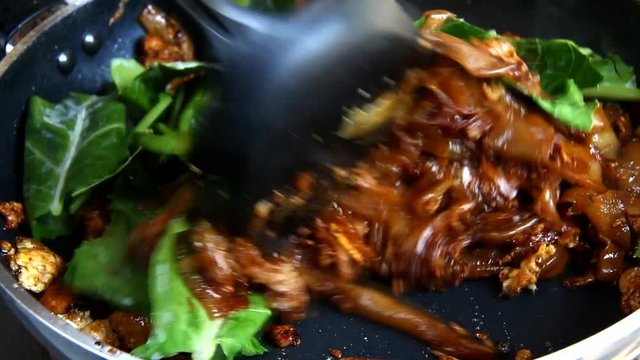frying flat noodle and pork with preserved soy bean paste