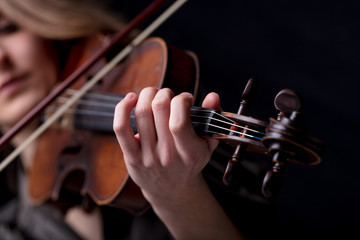 closeup of a violinist's hand playing