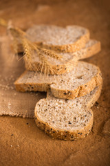 sliced whole wheat bread on dark background.