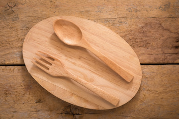 wooden spoon and fork on wooden background.