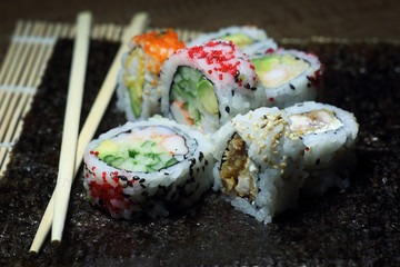 Sushi roll. Sushi roll with shrimp tempura. Fresh and delicious maki and nigiri sushi. Healthy kale and avocado sushi roll with chopsticks. Japanese food. Japanese favorite food sushi maki.