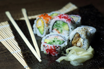 Sushi roll. Sushi roll with shrimp tempura. Fresh and delicious maki and nigiri sushi. Healthy kale and avocado sushi roll with chopsticks. Japanese food. Japanese favorite food sushi maki.