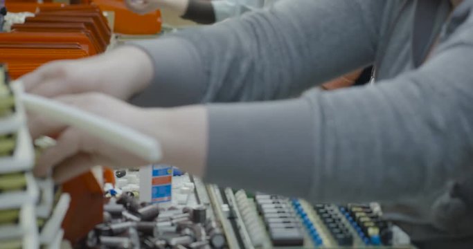 Workers manually assemble Electronic parts on PCB