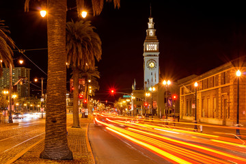 Fototapeta na wymiar Night Street - A night view of the busy Embarcadero street at front of the Ferry Building, San Francisco, California, USA. 