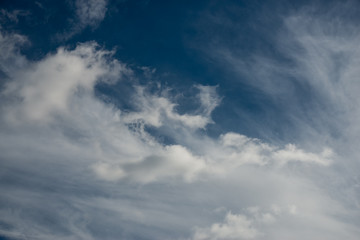 Naklejka na ściany i meble Blue sky with fluffy cotton clouds background