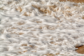 water breaking on sand background