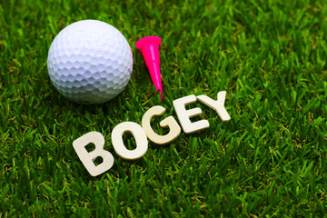 Bogey wording with golf ball on green grass