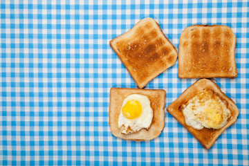 Breakfast. Toast and eggs on a blue table