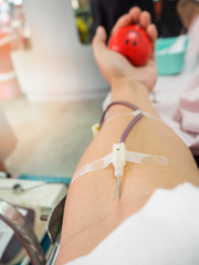 Nurse receiving blood from blood donor in hospital.