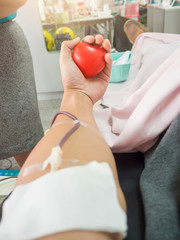 Nurse receiving blood from blood donor in hospital.