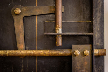 closeup of industrial looking inner workings of an old bank safe interior door