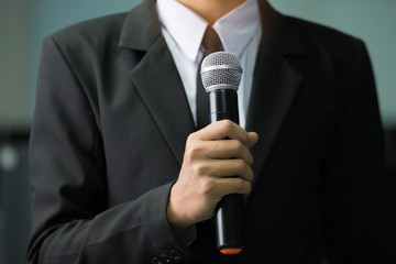 blurred of smart businessman speech, talking with microphone, gray scale tone