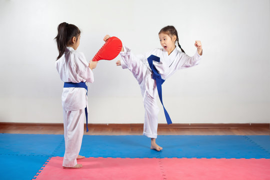 Two little girls demonstrate martial arts working together