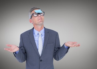 Businessman with sticky note stuck on his forehead