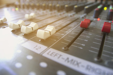 Volume slide audio mixer in the recording studio.