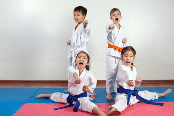 Fototapeta na wymiar Four children demonstrate martial arts working together