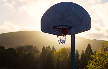 Backlit Basketball Hoop at Sunset