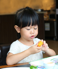 Adorable child girl eating Deep-fried Cheese Stick