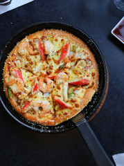 DeliciousSeafood Pizza in tray on table