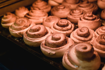 Obraz na płótnie Canvas sweet rolls with cinnamon are baked in an oven, a background, food