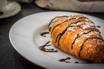 Croissant with chocolate and coffee