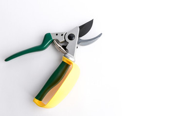 Green garden secateur with arm protection yellow, on white background