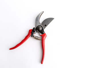 Red garden pruner on the white background