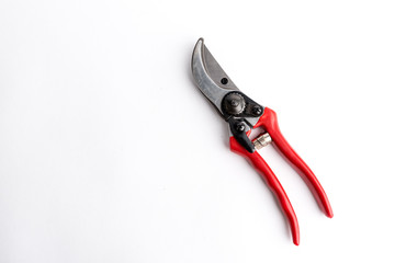 Red garden pruner on the white background