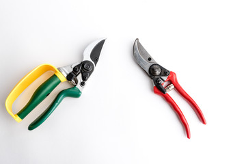 Obraz na płótnie Canvas Green garden secateur and Red garden pruner with arm protection yellow, on white background