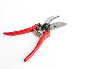 Red garden pruner on the white background