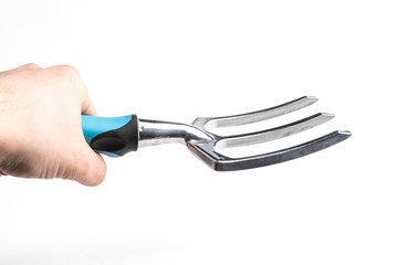 Small garden tool. Rake, used to loosen the soil