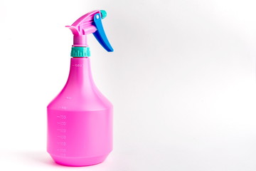 Small liquid atomizer of different colors on a white background, lilac. sprayer