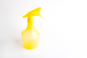 Small liquid atomizer of different colors on a white background, yellow sprayer