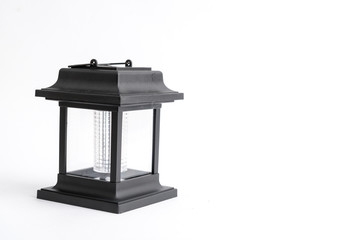 Garden lantern on solar panels in black, photographed on a white background in the studio. Vintage