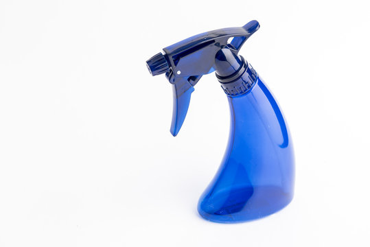 Small liquid atomizer of different colors on a white background, blue sprayer
