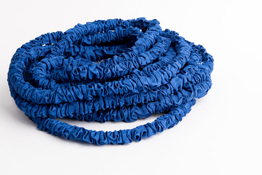 The hose of a garden hose of blue color, made of modern materials, can grow in size, stretchable