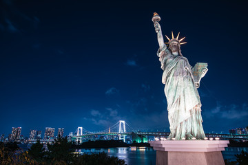 View from Odaiba of rainbow bridge and statue of liberty - Tokyo, Japan