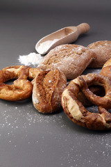 Different kinds of bread and bread rolls on board from above. Kitchen or bakery poster design.