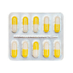 Blister pack of yellow and white capsules isolated on white