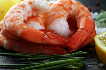 Delicious sauteed shrimp heart with cajun seasoning and lime on dark stone