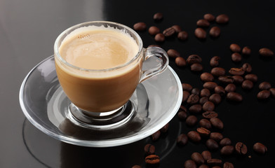 Coffee cup and coffee beans on table
