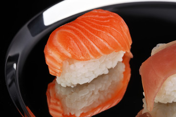 close up of sashimi sushi set with chopsticks and soy - sushi roll with salmon and sushi roll, delicious maki and nigiri