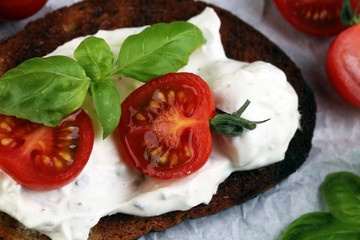 Bread with cream cheese and tomato for lunch table. Sharing antipasti on party or summer picnic...