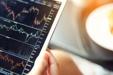 trading online on tablet with business woman hand