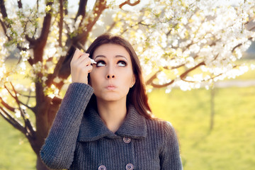 Woman with Spring Allergies Using Eye Drops